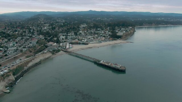 Aerial: Capitola wharf, cliff and beach, Santa Cruz, USA