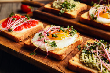 Wooden boards with delicious toasts, closeup