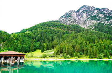 Heiterwanger See in Austria. View of the blue-green lake and the surrounding mountains. Landscape near Heiterwang.