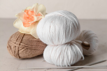 Fototapeta na wymiar Knitting yarn, needles and narcissus flower on light table