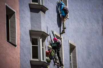 Display dummies climbing on the building