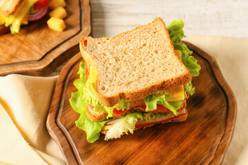 Board with tasty sandwich on table, closeup