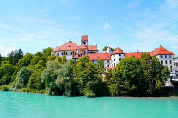 Fototapeta na wymiar Lech near Füssen. River in Bavaria with turquoise clear water and surrounding landscape.