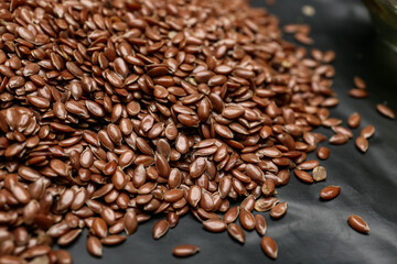 Flax seeds on dark background, closeup