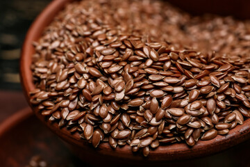 Bowl with flax seeds on table, closeup
