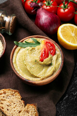 Bowl with tasty baba ghanoush on dark table, closeup