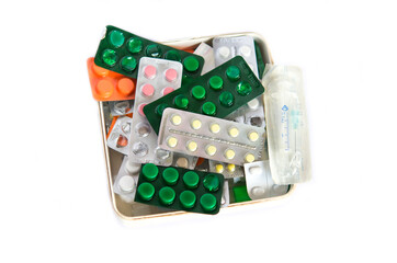 Blisters with pills, packaging with pills and capsules on a white background