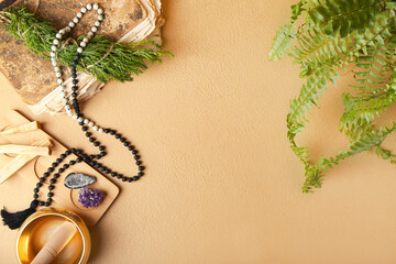 Composition with Tibetan singing bowl, gemstones, beads and Palo Santo on color background