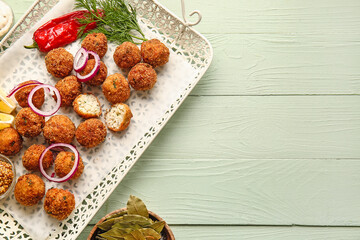 Fototapeta na wymiar Tray with tasty cod cutlets, mustard and spices on color wooden background