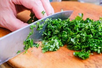 Parsley Cutting knife wooden board. raw cook.