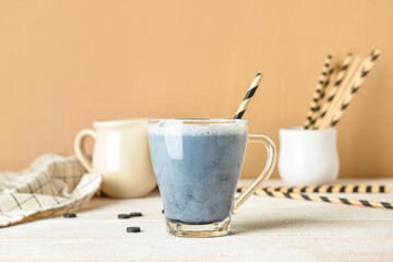 Glass cup of tasty Charcoal Latte on table