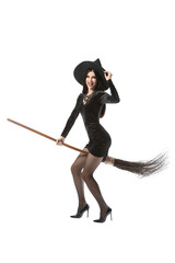Young witch with broom on white background