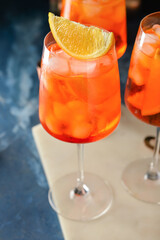 Glasses of tasty aperol spritz cocktail on color background