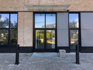 Modern real estate, residential apartment building, entrance with glass canopy and door