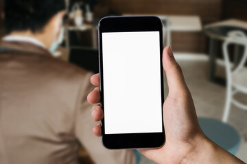 Women are using a mobile phone wifi connection on the desk with a cup of coffee in the morning.