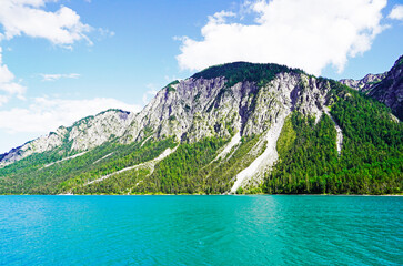 Landscape at the Plansee in Tyrol, Austria. Turquoise colored lake with surrounding landscape and mountains.