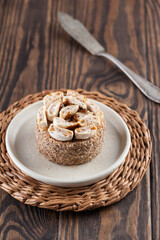 Delicious cake in a plate on a dark wooden table.