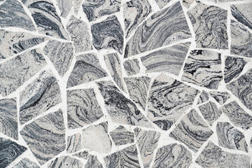 Gray, black and white mosaic floor. Stone floor. Stone background.
