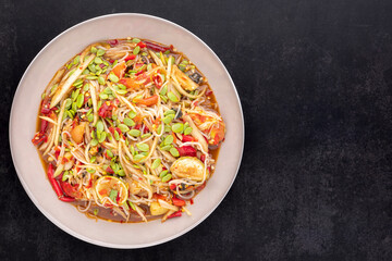 Tum Pa, Som Tum, Thai food, spicy papaya salad with Thai rice noodle, golden apple snail (Pomacea canaliculataLamarck), Leucaena leucocephala seed (Lamk seed), lime, tomato, pickled fish and chilli