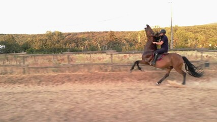 rider training with his horse in the training field of the riding arena