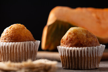 Pumpkin muffins on wooden table
