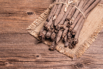Bunch of raw Scorzonera or Spanish salsify on vintage wooden table