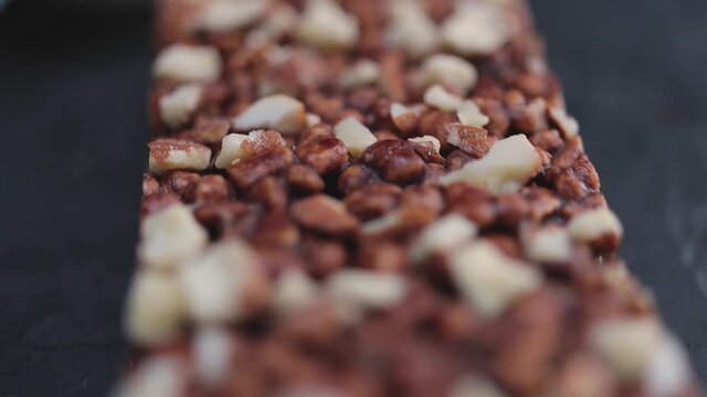 Chocolate protein bar with nuts, close-up view