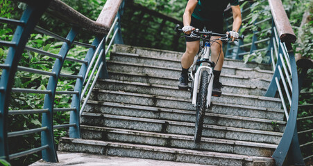 Woman freerider riding down stairs. Sports extreme and active lifestyle