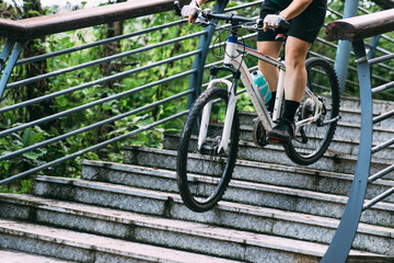 Naklejka premium Woman freerider riding down stairs. Sports extreme and active lifestyle
