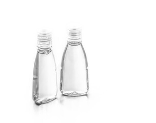 Two transparent bottles  with shampoo, sanitizer gel or body lotion, isolated on white