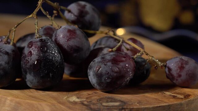 Close up of dark red grapes on wooden board