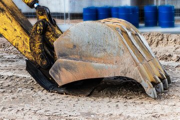 Excavator bucket close up. Excavation work at construction site and road construction. Construction machinery.