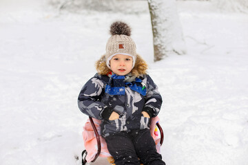 child playing with snow, playing with snow,child playing in winter