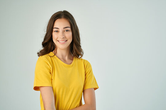 cheerful brunette in a yellow t-shirt posing fashionable hairstyle smile model