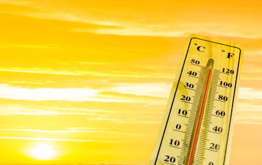 Thermometer with extreme temperature and dramatic clouds. Conceptual image symbolizing a drastic climate changes on our planet 
