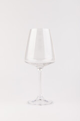 Empty transparent wine glass on the white background
