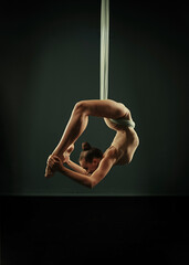 Beautiful gymnast in a leotard does yoga homosexual exercises