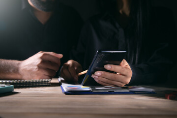 Businesswoman using mobile phone at office meeting