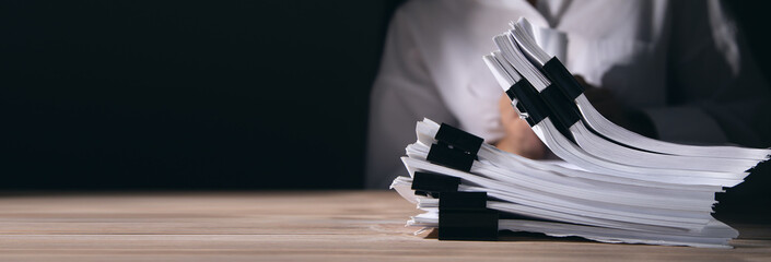 woman holding stack of documents