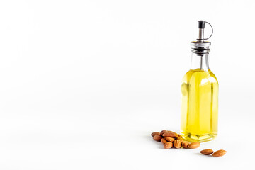 Almond oil in bottle with almond nuts. Extra virgin essence oil