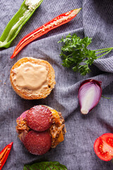 Hamburger with sausage, meatballs and caramelized onions.