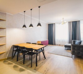 Modern interior of light living room in studio apartment with furniture.