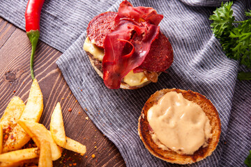 Bacon burger, caramelized onions and french fries.