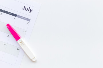 Pregnancy test with calendar to check pregnancy day