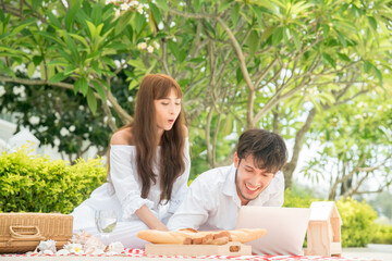 Asian young couple at picnic at the resort