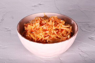 cabbage stewed with tomato is on the table