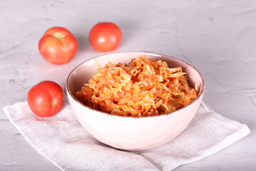 cabbage stewed with tomato is on the table