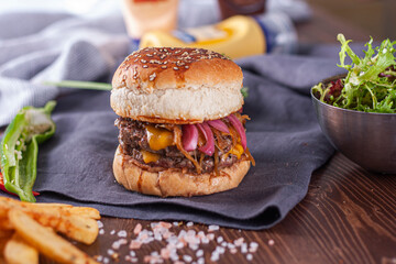 Burger with cheddar cheese and caramelized onions.
