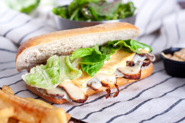 Sandwich with fresh green vegetables and smoked chicken.