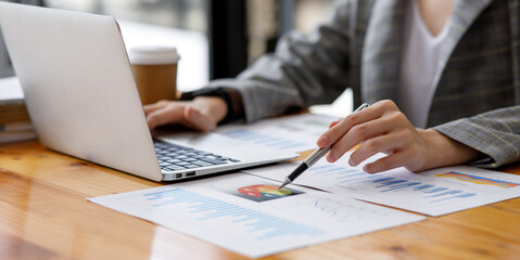 Close up of hand,Financial Businesswomen analyze the graph of the company's performance to create profits and growth, Market research reports and income statistics, Financial and Accounting concept.